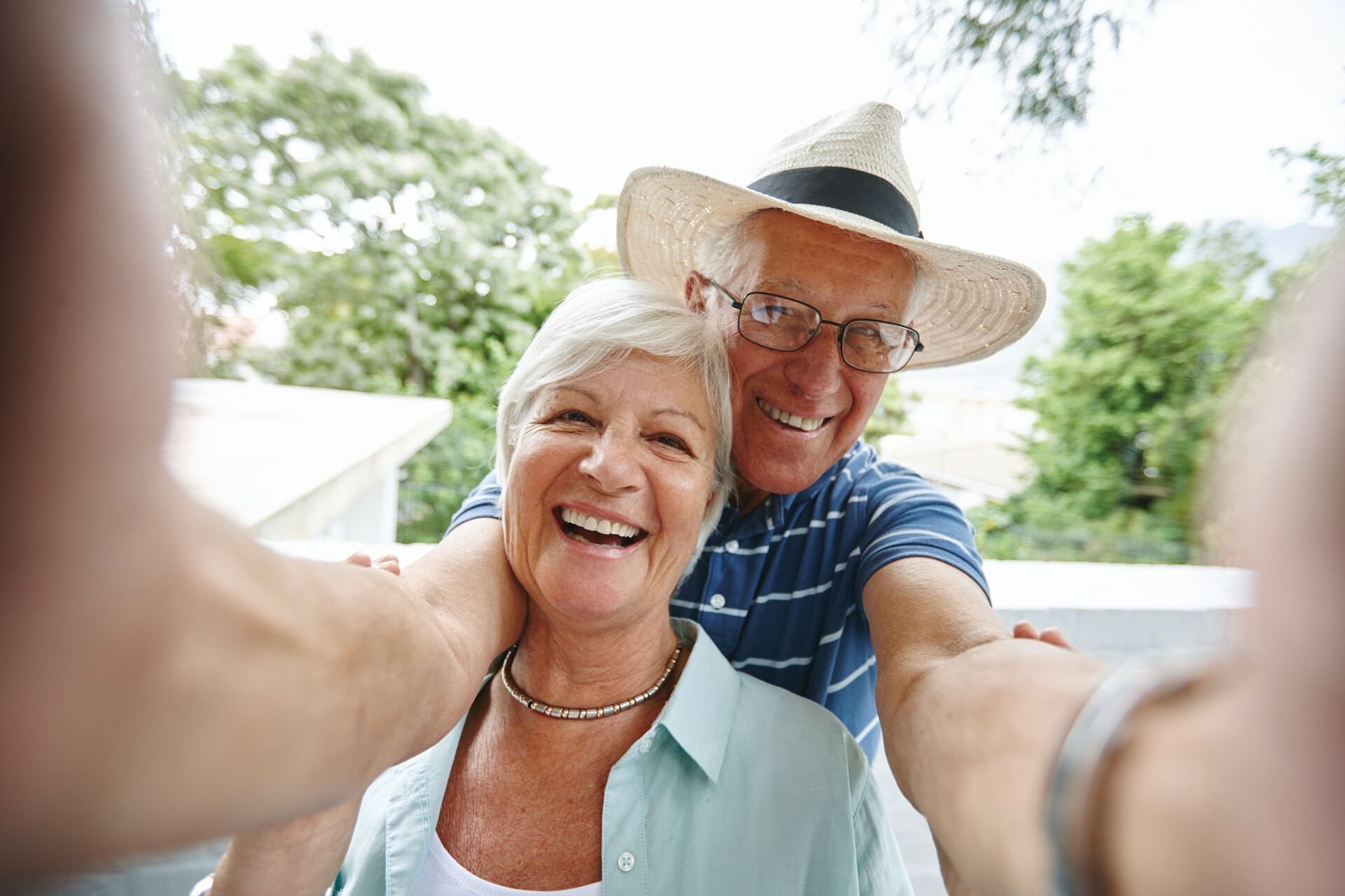 An older couple taking a selfie.