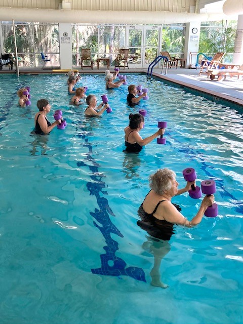 A group of people in an indoor swimming pool.