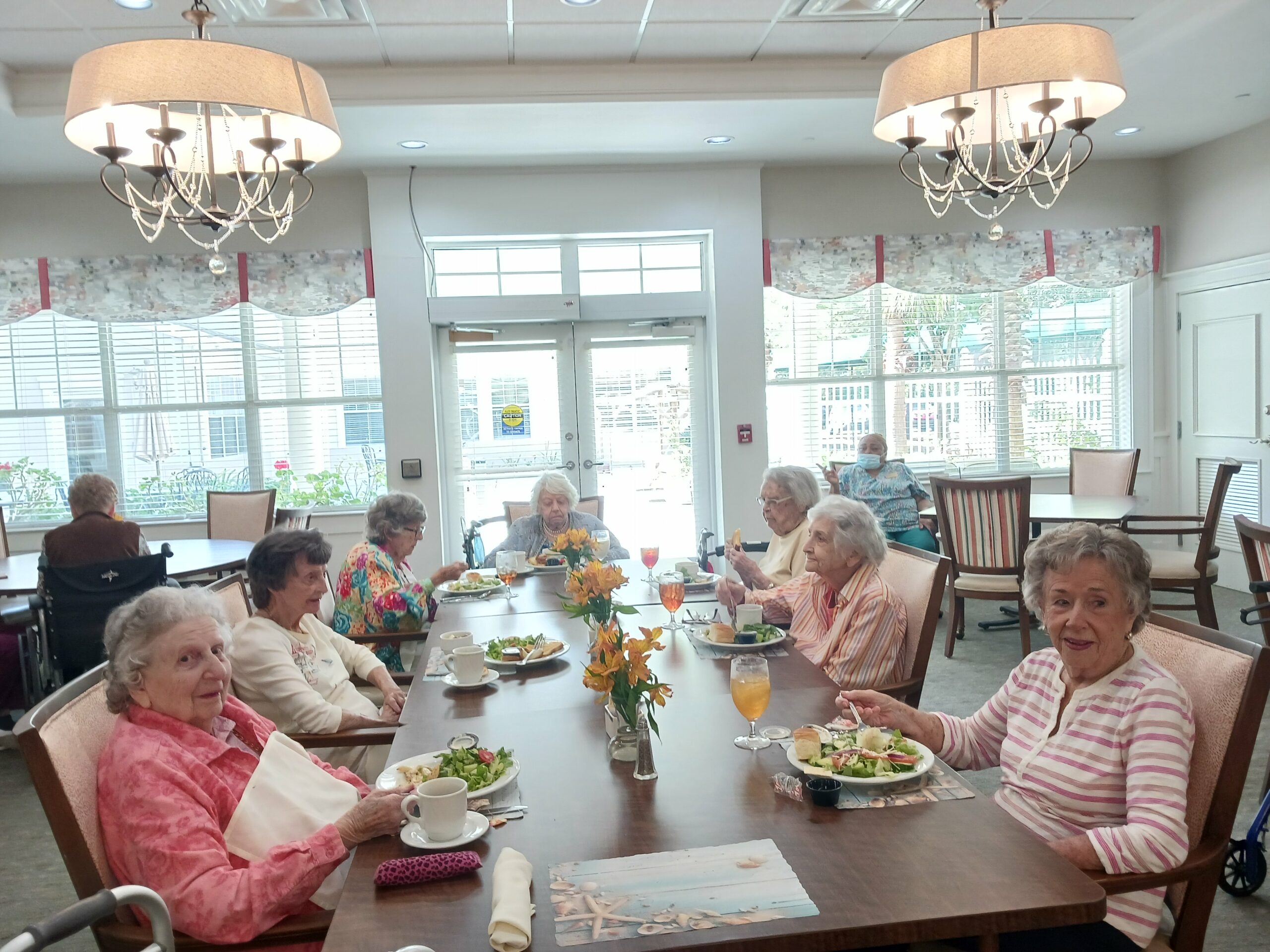 A group of elderly women sitting at a table.