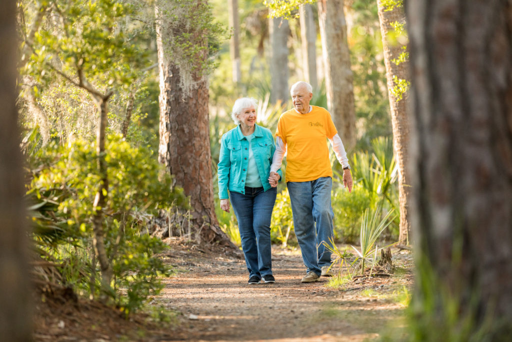 An elderly couple walk in a park in the marshes near Savannah