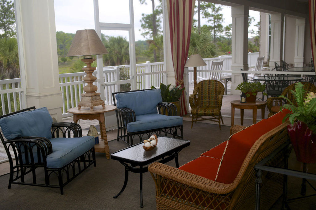 Comfortable chairs and couches line a wide open air deck